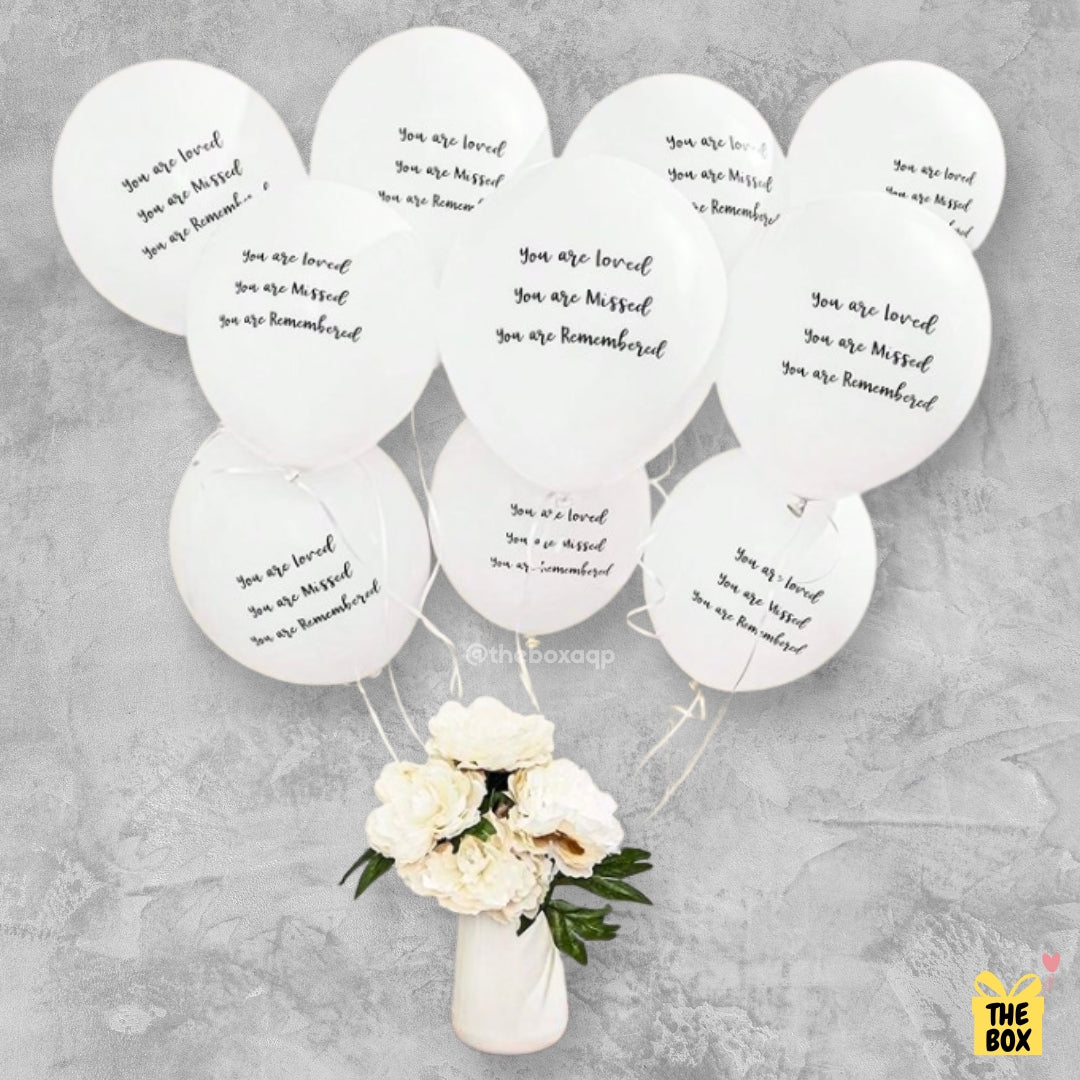 Globos blancos de despedida a un ser querido